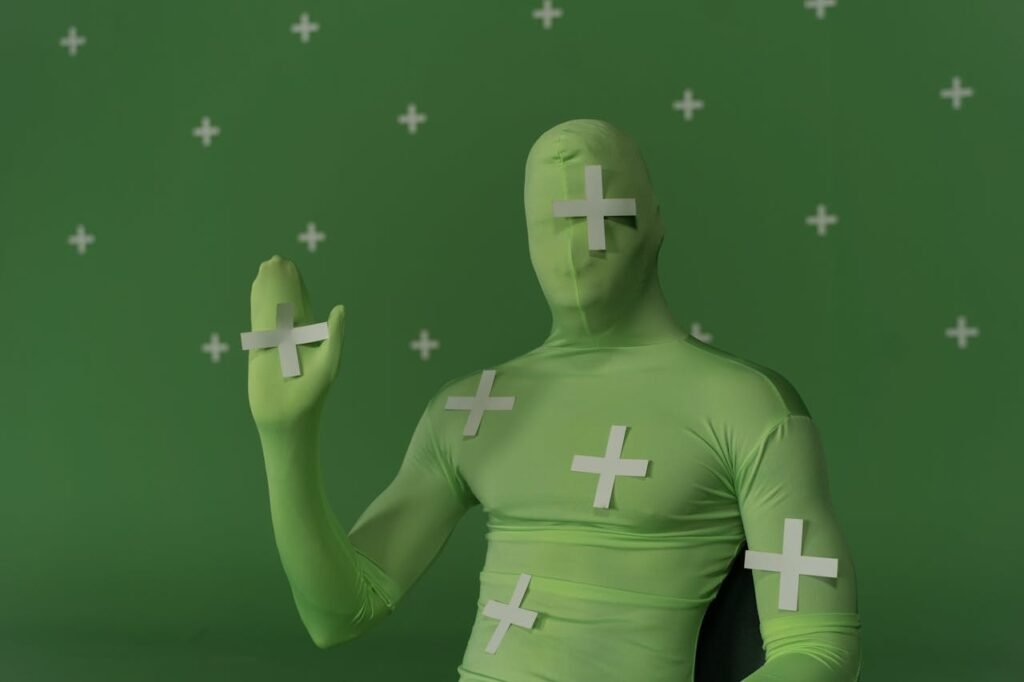 Person in a green suit wth motion trackers around