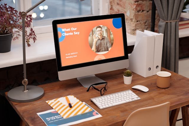 Office desk with a computer - website landing page visible.