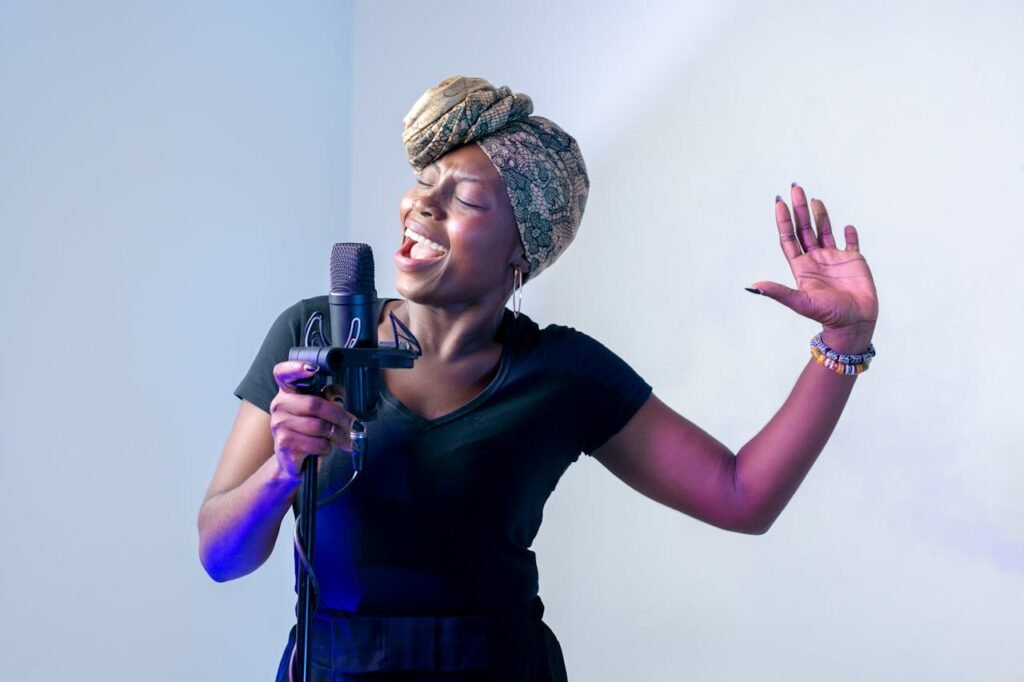 Musician singing into a microphone passionately